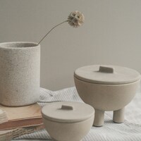 Two lidded ceramic jars with three legs each by Anya Chernykh