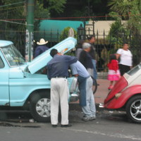 Fixing a car (streets of Mexico City, Mexico 2005)