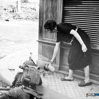 French woman pouring tea for a British soldier fighting in Normandy 1944