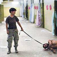 A US soldier humiliating an Iraq prisoner