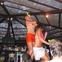 Beautiful ladies dancing at Pounda Beach Bar, Paros Island, Greece