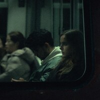 People riding on a train at night by Valentin