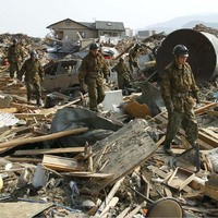Soldiers search for victims among the rubble at Rikuzentakata