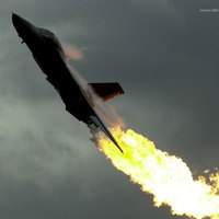 FLAMES COMING OUT OF THE REAR OF FIGHTER JET.