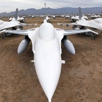 F-16 Fighting Falcons coated with sealing paint in aircraft boneyard