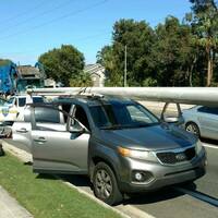 Two men are arrested for stealing a utility pole.. by strapping it to their car