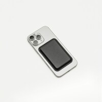 Silver smartphone with black magnetic wallet on a white background by Adrian Regeci