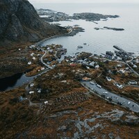 Coastal village nestled between mountains and sea by Julien Riedel