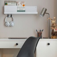 A modern desk with headphones, books, and a lamp by Aleksandra Dementeva