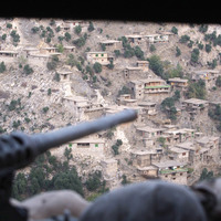 A 50 caliber machine gun points out towards an Afghan village October 23, 2008