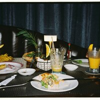 Table with leftover food and drinks after meal by Aleksandra Dementeva