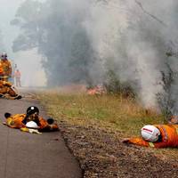 Exhausted firefighters take a rest before the front comes, NSW, Australia