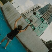 Man playing basketball on a blue court by Hanna Lazar