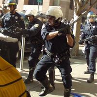 cop beating up newsreporters