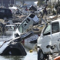 Vehicles block a canal in Tagajo in Miyagi prefecture on March 13, 2011