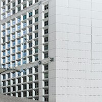People walking up the wide stone steps of the Grande Arche in Paris by Hao Wu