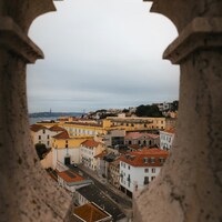 View of a european city through stone arches by Ryan Klaus