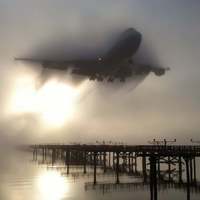 747 breaking through the morning fog