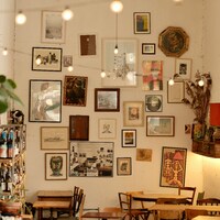 A cozy cafe interior with art and hanging lights by Zuoranyi