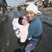 As a tsunami warning blares, a father tries to flee for safety in Ishinomaki