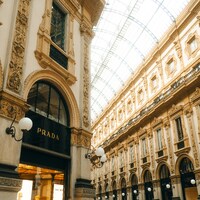 Ornate building interior with a prada store entrance by Lens by Benji
