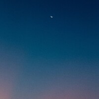 Crescent moon in a gradient twilight sky by Klara Kulikova
