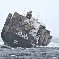 Containers tumble into the sea as cargo ship Rena hits a reef