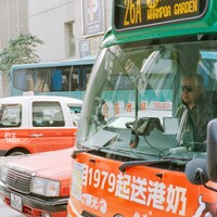 Bus driver behind the wheel in a city street by Zhen Yao