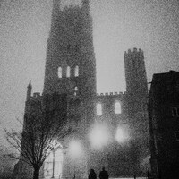 Two figures walk towards a large cathedral in fog by Phil Hearing