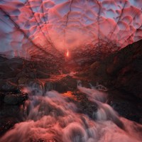 Ice cave lit by a flare