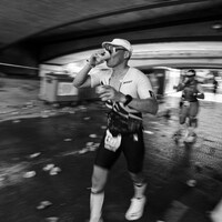 Runner drinks from cup during a race by charlie dt