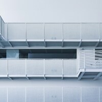 Modern white building with balconies and stairs by Declan Sun