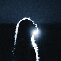 A silhouette of a person with long hair against a bright light source by Max Ovcharenko