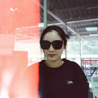 Woman wearing sunglasses indoors with blurred foreground by krzhck